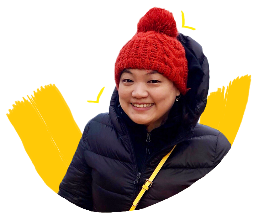 A smiling Korean woman wearing a red beanie and a black parka.