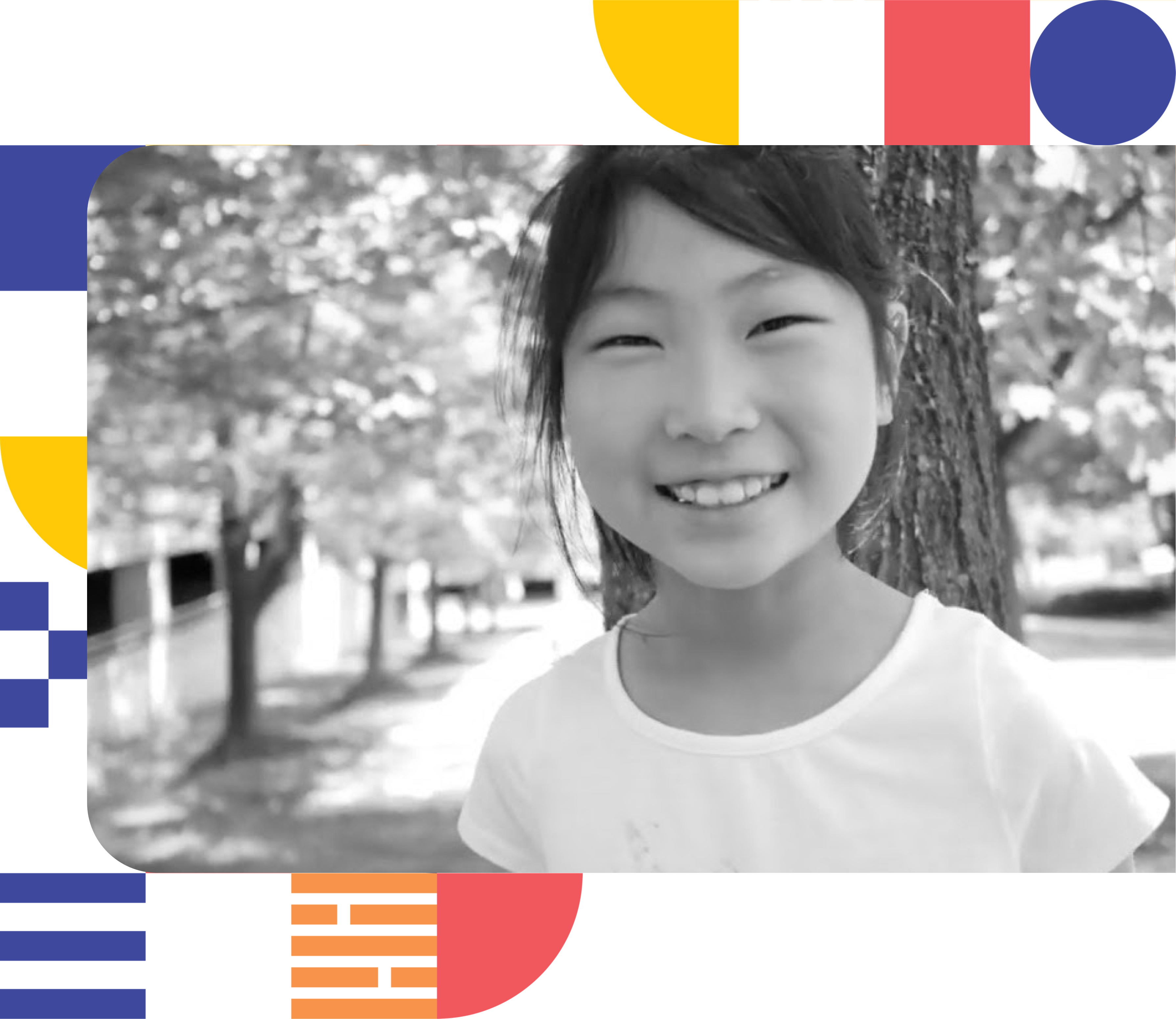 A smiling Korean American child standing in a brightly lit park in Annandale.